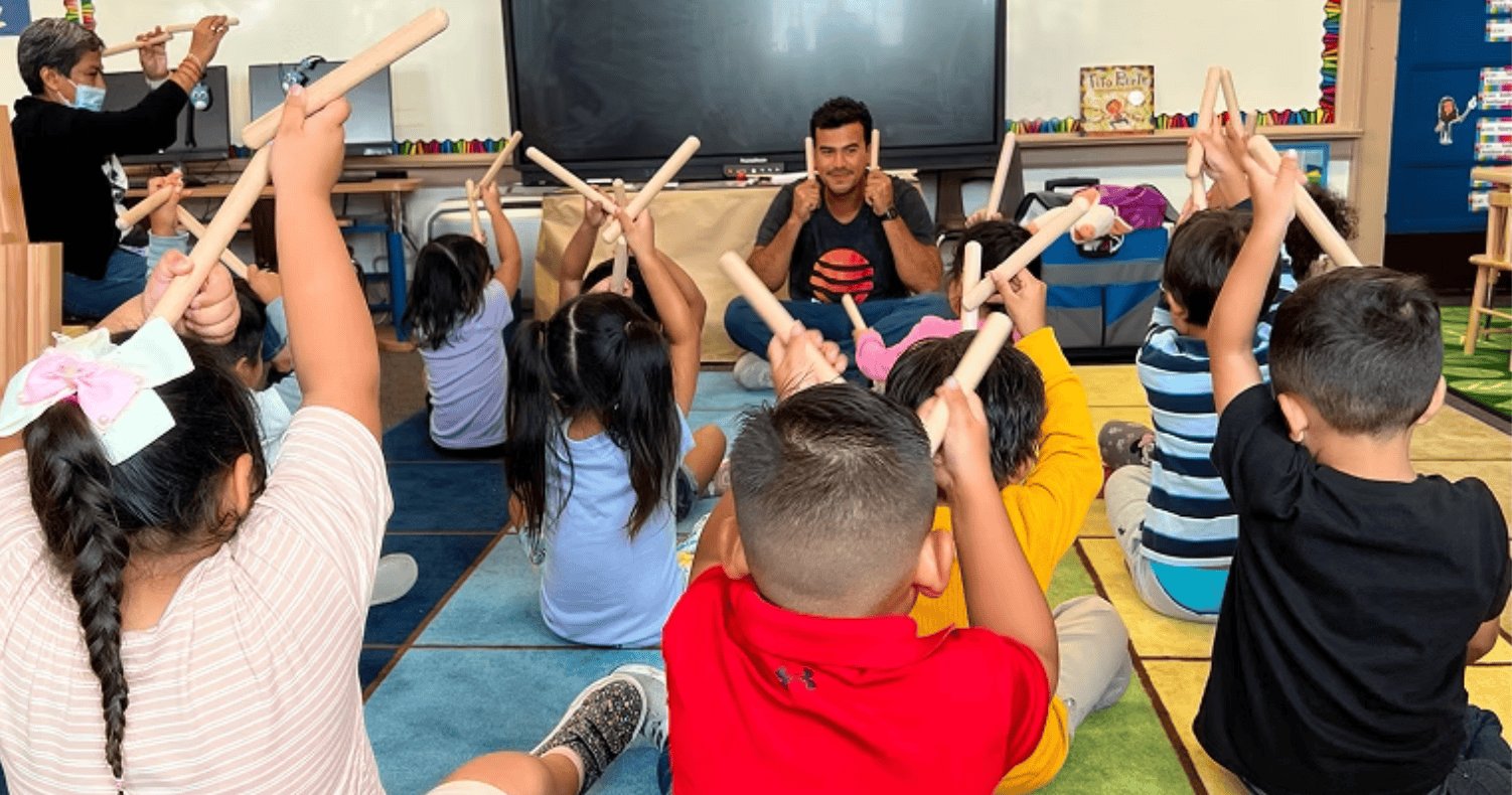 Gabriel teaching with rhythm sticks