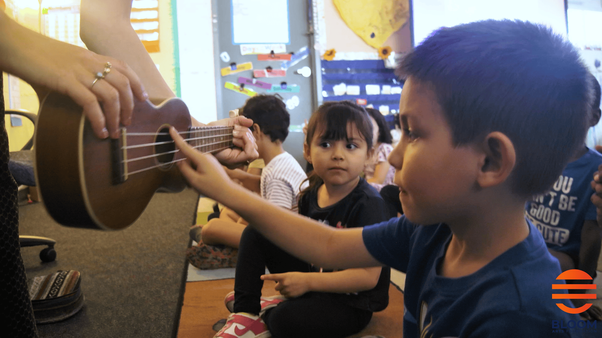 Student playing ukulele in Ms. Alvarez's classroom